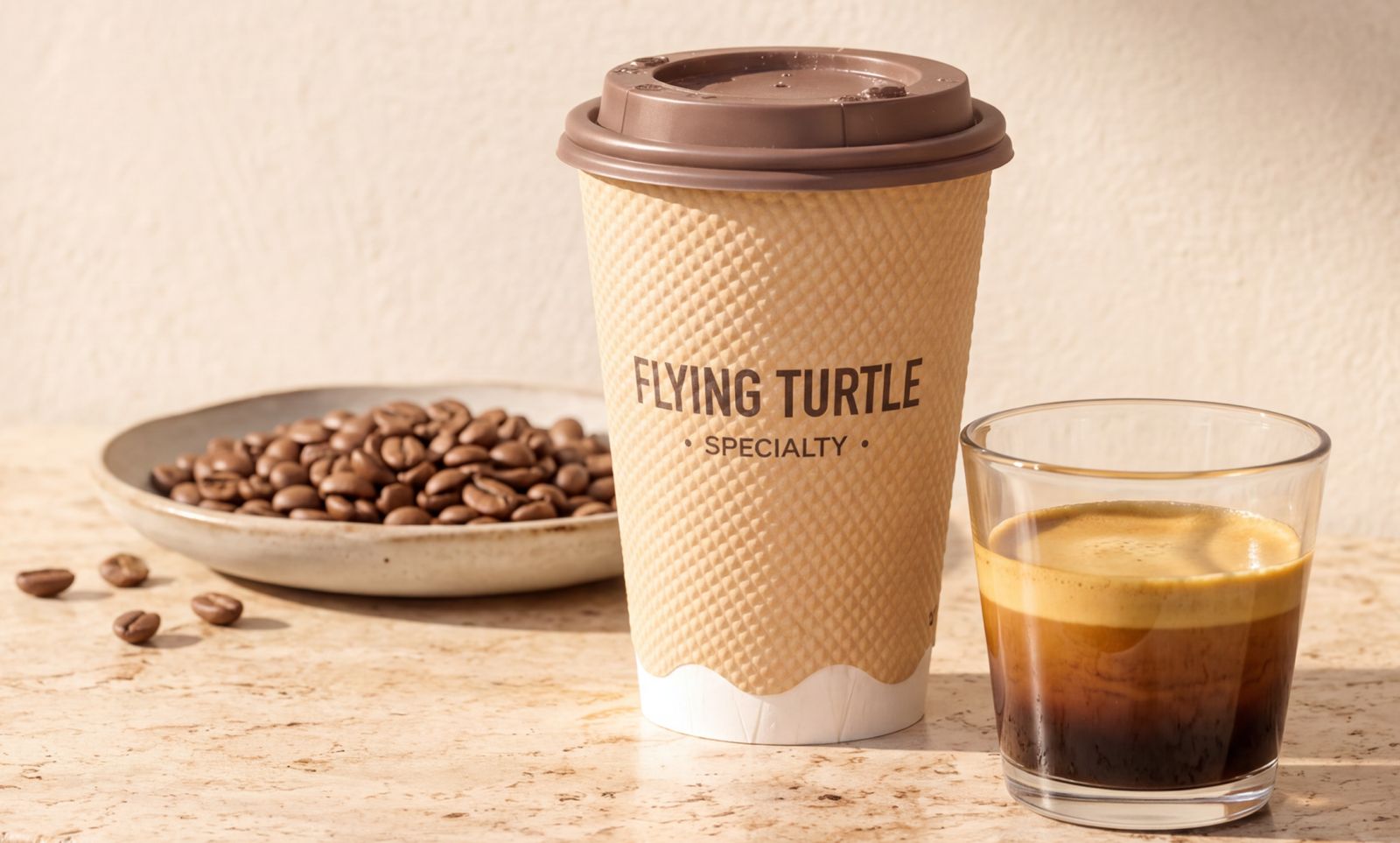 A Flying Turtle Specialty cup beside an espresso and a plate of coffee beans